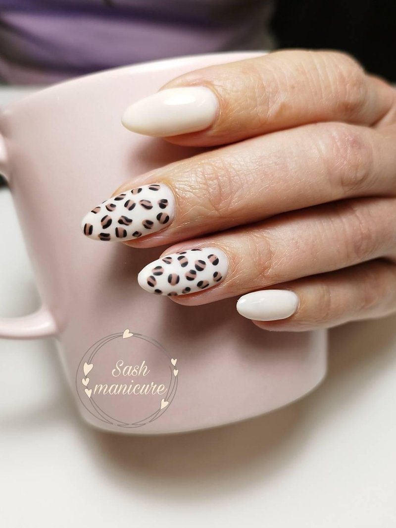 Crème nagels met een luipaardprint rond een roze mok